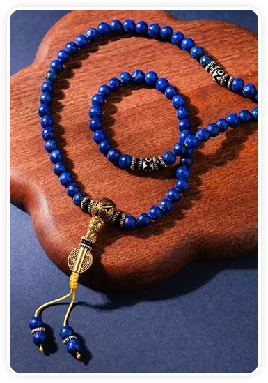 Lapis Lazuli mala coiled in an open hand, close-up bead detail