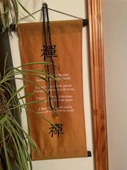 Wooden wall hanging with the Zen symbol, paired with a Lapis Lazuli mala