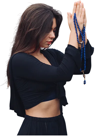 Woman holding a Lapis Lazuli mala in a prayer position during meditation