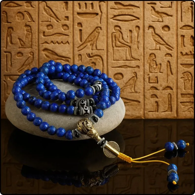 Lapis Lazuli mala necklace displayed against an ancient hieroglyphic backdrop