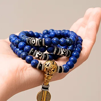 Lapis Lazuli mala bracelet held in hand, showing bead detail