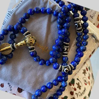 Lapis Lazuli mala displayed on soft fabric