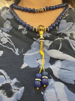 Lapis Lazuli mala tassel detail on patterned fabric